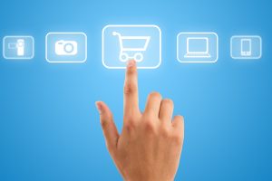 Hand choosing shopping cart symbol from media icons on blue